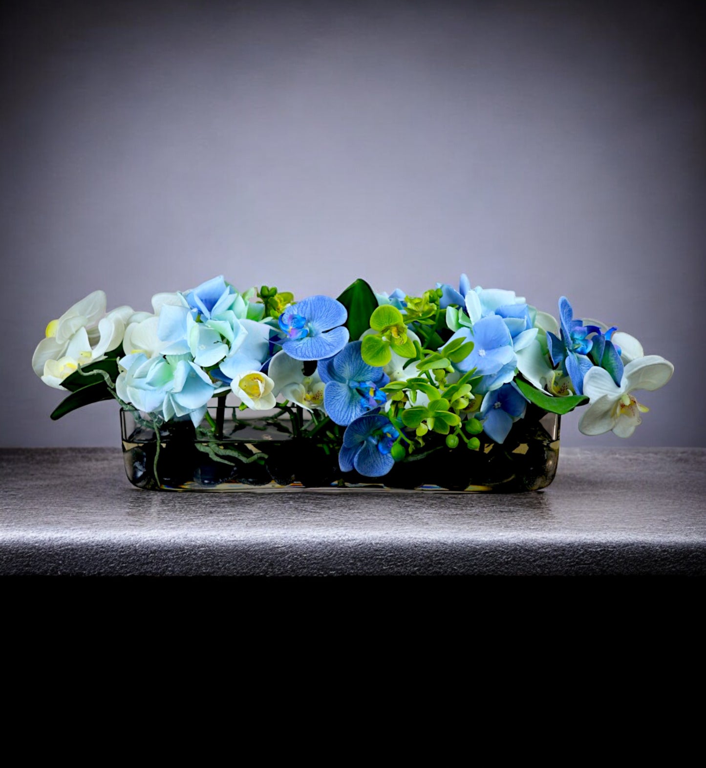 Blue Floral Arrangement in Long Glass Vase